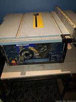 Front and top view of the Mastercraft portable table saw showing blade area, fence guides, and power switch.