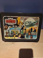 Front exterior of the Star Wars Empire Strikes Back carrying case, showing detailed character graphic.