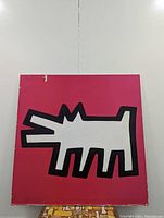 Front view showing Keith Haring Barking Dog image on vibrant pink background with some edge wear and chipping.