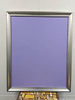 Front view of the painting featuring a smooth silver-toned vintage frame with a purple matte area in the center, likely representing a placeholder or the painting surface.