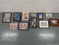 Full lot of 11 framed arts including two original paintings on wall
