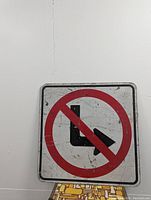 Front view of vintage 'No Right Turn' road sign showing scratches and wear.