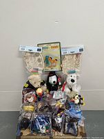 Photo of multiple vintage toys including Gumby & Pokey anniversary toy, Snoopy plush, teddy bears, Groovy Wood craft paint sets, and McDonald's character toys