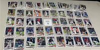 Top view of multiple 2021 Bowman 1st Edition baseball cards arranged in rows showing players in various baseball poses.