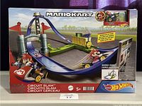Front view of packaging showing MarioKart Circuit Slam track with Mario kart vehicle on track.