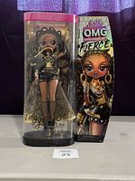 L.O.L. Surprise OMG Fierce Royal Bee doll in original display packaging alongside the illustrated doll box.