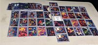 Overview of 66 Marvel Masterpieces cards from 1994, laid out in rows on a beige surface, featuring a variety of superheroes and villains.