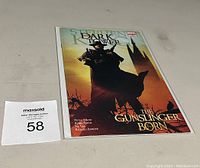 Comic book in clear protective sleeve showing cover art with silhouette and title.