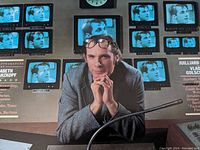 Close-up image of Glenn Gould on album cover surrounded by multiple TV screens showing his face.