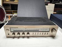 Front view of vintage Marantz SR-225 stereo receiver showing control knobs, tuning dial, and power button on silver faceplate.