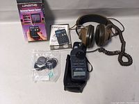 Overview photograph of all items in the lot including headphones, sound level meter, remote control and accessories.