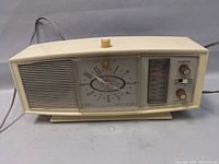 Front view of the Silvertone transistor radio showing speaker grille, clock, and tuning interface with knobs.