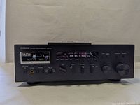 Front panel view of Yamaha R-5700 receiver showing display, knobs, buttons