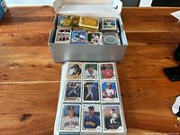 Box showing assortment of baseball cards displayed in sleeves and loose, several player images visible including Tim Crews, Roger Salkeld, Mark Lemke, and Will Clark.
