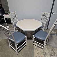 Full view of five piece dining set showing octagonal table and four chairs with blue vinyl seats.