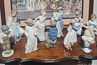 Overview of all ten porcelain figurines arranged in rows