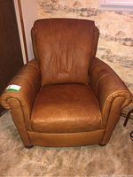 Front view of the leather armchair showing overall shape and appearance