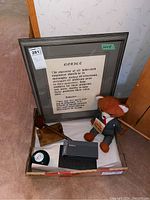 Lot displayed showing all items including framed print, teddy bear, gavel, magic poker ball, pens in boxes, and gavel stand excluded