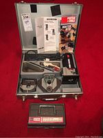 Full view of metal carrying case with Porter Cable trimmer, accessories, instructions, and Craftsman router bit set