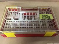 Photo of the carry case top down, showing the inside compartments and grid base for securely holding cars.