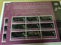 Block of collectible postage stamps with purple background and imagery related to Holocaust remembrance.