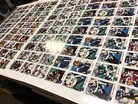 Three large uncut pages of CFL football cards laid out flat, showing multiple individual cards featuring images of players in various poses and team uniforms.