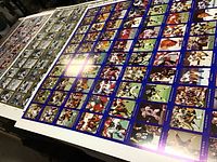 Three large uncut sheets of CFL football cards displayed on a table, showing multiple rows of player cards with colorful borders.