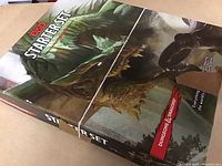 Boxed Dungeons & Dragons Starter Set with dragons artwork on cover, secured with rubber bands.