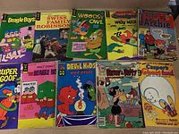 Full lot of 10 vintage cartoon comic books showing covers with Beagle Boys, Swiss Family Robinson, Woodsy Owl, Goodnight Wally Wugg, Little Archie, Super Goof, Devil Kids, and Casper comics.