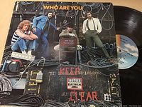Photo showing The Who "Who Are You" vinyl LP album cover featuring the band members and electrical cables.