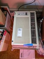 Top view of Kenmore room air conditioner showing front air vents and control buttons with label on top.