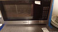 Front view of Panasonic microwave showing stainless steel finish and brand name on door.