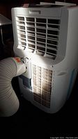 Rear view of the Honeywell portable air conditioner showing ventilation grilles and attached exhaust hose.