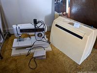 Kenmore sewing machine, foot pedal and carrying case visible, showing assembled machine and pedal on table