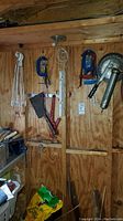 Workshop shed wall with clamps and vise mounted, hand tools hanging