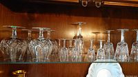 Shelf display showing two larger diamond–cut goblets, three smaller cordial glasses, and a tall wine glass