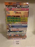 Stack of 15 anime DVDs showing variety of Japanese anime titles, colorful spines, and artwork on cases.