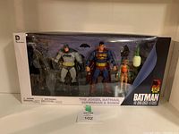 Front view of unopened box with all 4 action figures visible through window
