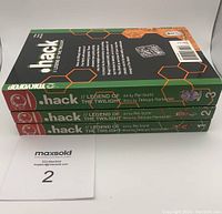 Three volumes of .hack Legend of the Twilight manga stacked horizontally showing project title and spine design with volume numbers 1, 2, 3