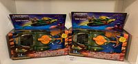 Two boxed Masters of the Universe Origins Wind Raider vehicles, sealed in original packaging, placed side by side on a shelf.