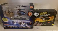Front view of the lot showing the Gyropter helicopter in its sealed packaging alongside the Helo helicopter box with touch control features highlighted.
