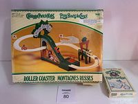 Photo of the original box for the Cabbage Patch Kids Roller Coaster toy and the sealed board game box.