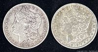 Obverse sides of two 1879 Morgan silver dollars showing Liberty profile and date