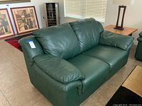 Front diagonal view showing overall shape, upholstery texture, and cushion styling