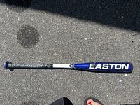 Full length photo of Easton baseball bat showing 'EASTON' lettering on the blue barrel and black grip tape on handle.