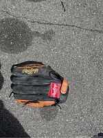 Top view of worn Rawlings baseball glove showing branding and black/brown color.