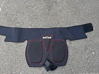 Black Bohning Butt Saver archery pad with padded front panels, red stitching, and adjustable Velcro waistband.