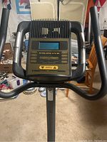 Front view of electronic display console with buttons and screen, showing Gold's Gym branding.