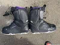 Pair of black Burton snowboard boots with visible lace locks, size 9.5.