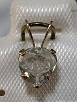 Close-up image of the pendant showing heart-shaped aquamarine set in 10K gold with prongs and bail visible.